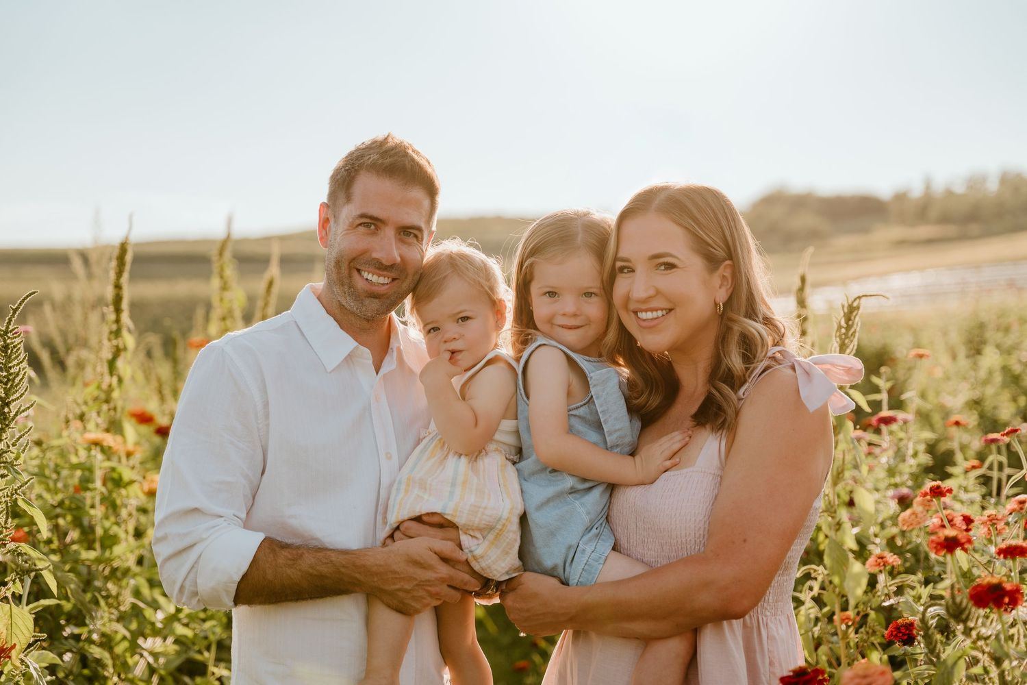 A loving family shares joyful moments together in a golden-lit field with red poppies at sunset.