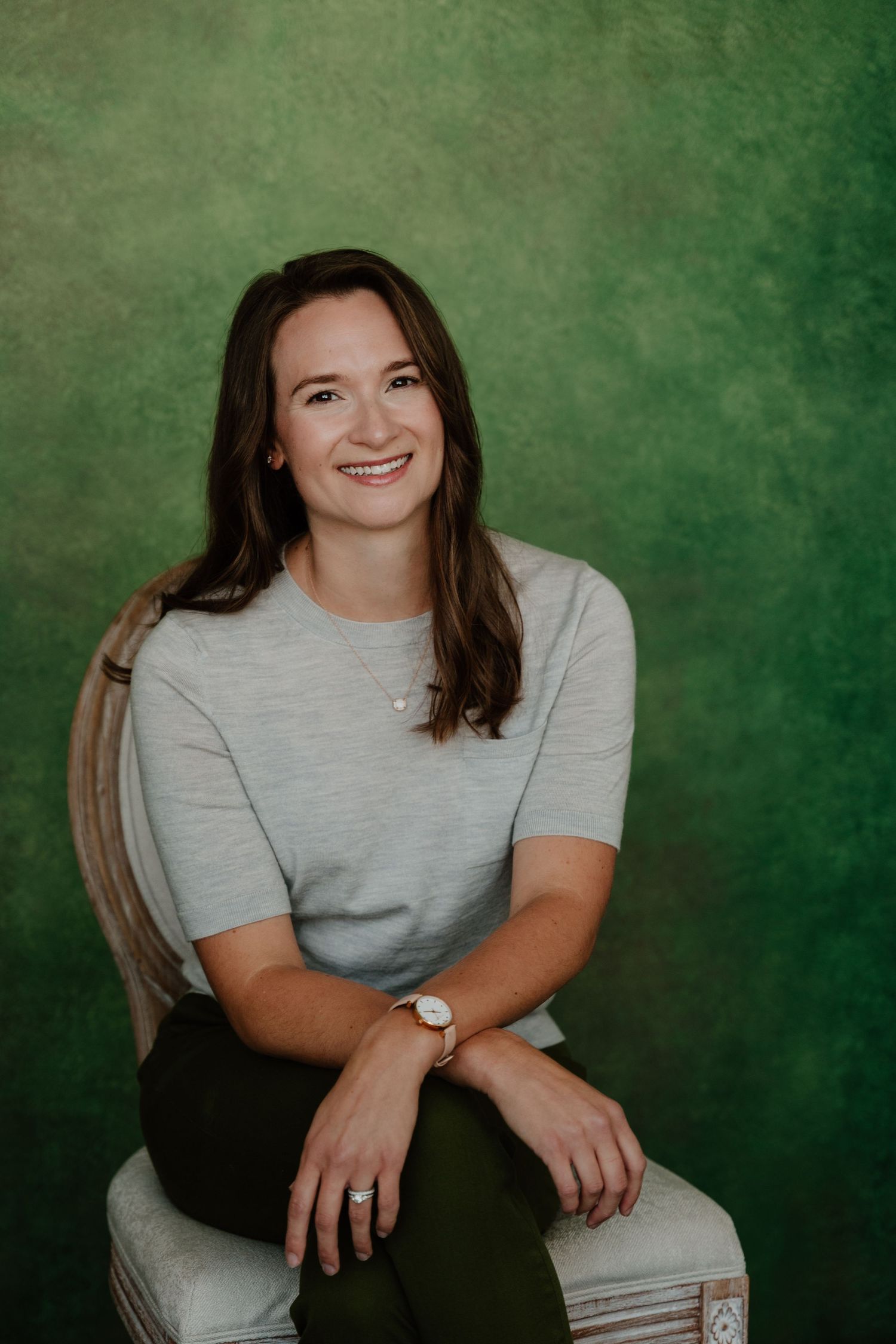 A series of four casual portrait photos against a textured green background showing relaxed poses in a gray t-shirt.
