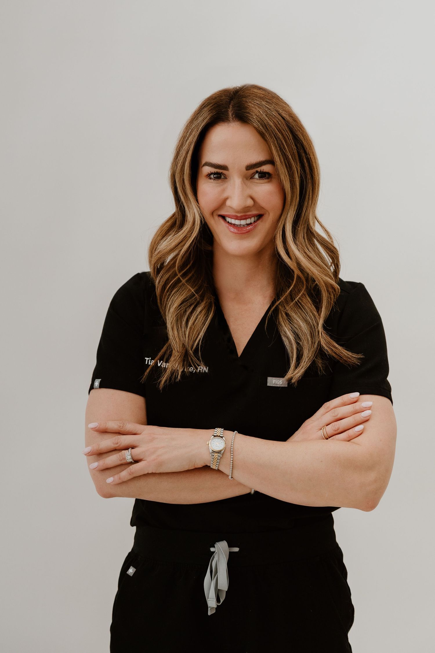 Professional portrait series showing a person in a black shirt with crossed arms and warm smile against white background.