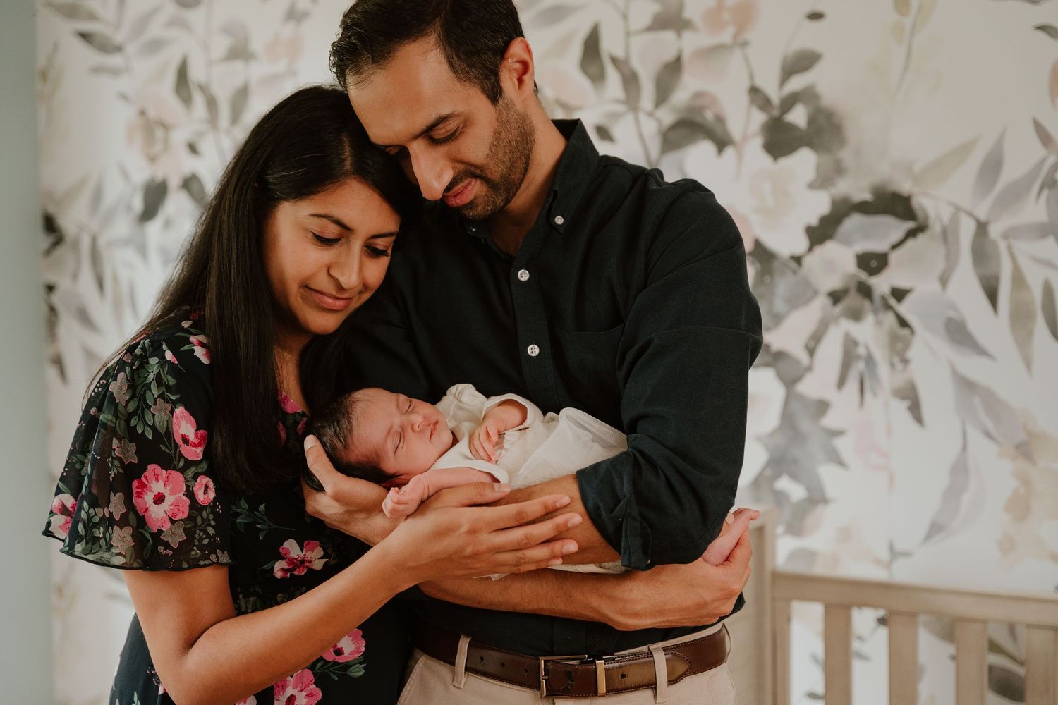 A series of tender family moments captured in black and white showing parents cradling their newborn baby.