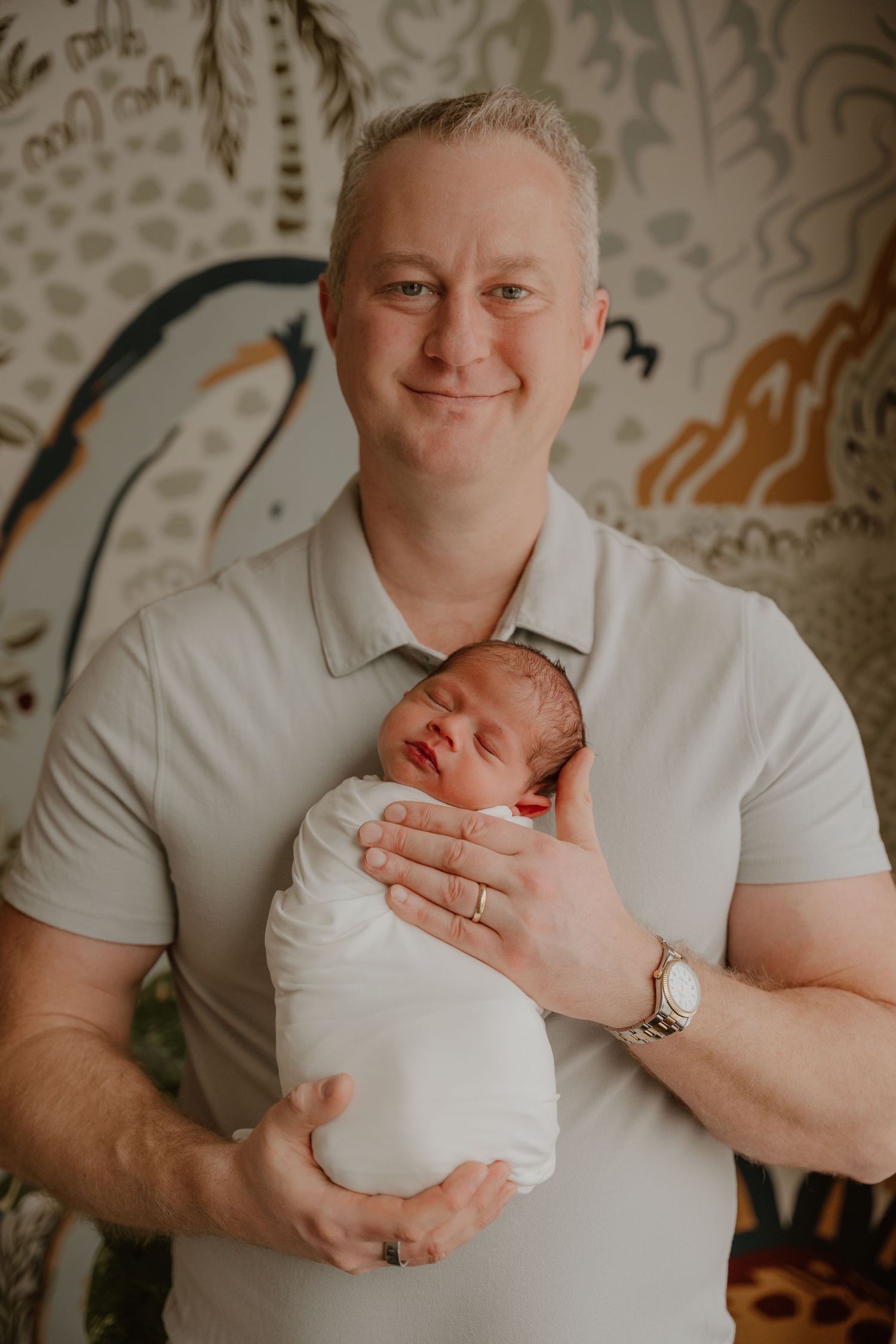 A person in a white polo shirt holds a newborn baby against their chest in a series of tender moments.
