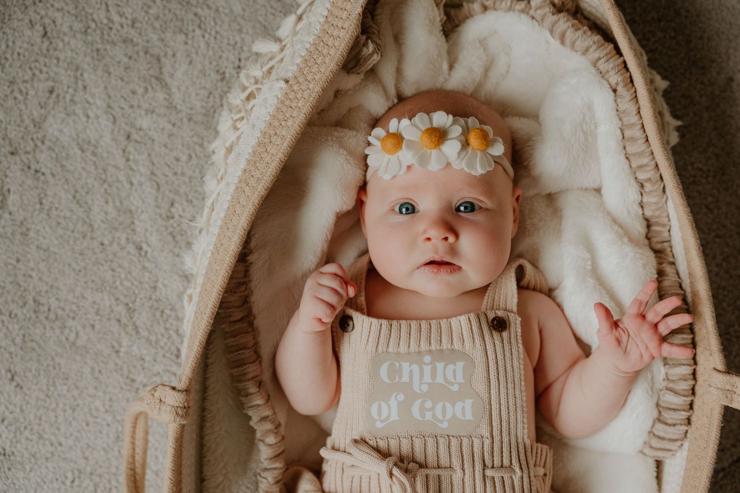 Baby wearing a floral crown lies on a cream blanket in a series of connected photos showing different poses.