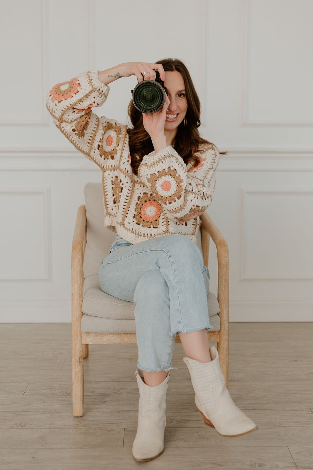 Four lifestyle photos showing someone seated wearing light blue jeans and cream boots with a decorative patterned top.