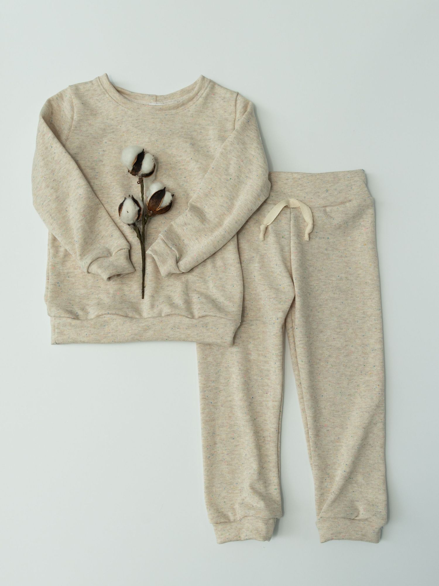 Organic cotton baby clothing set featuring a heather beige sweatshirt and matching pants laid flat against white background.