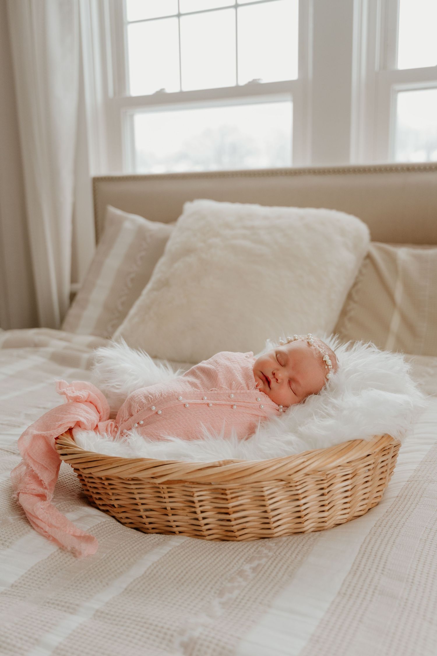 A series of four images showing a wicker basket with white and pink fabric on a light colored surface.