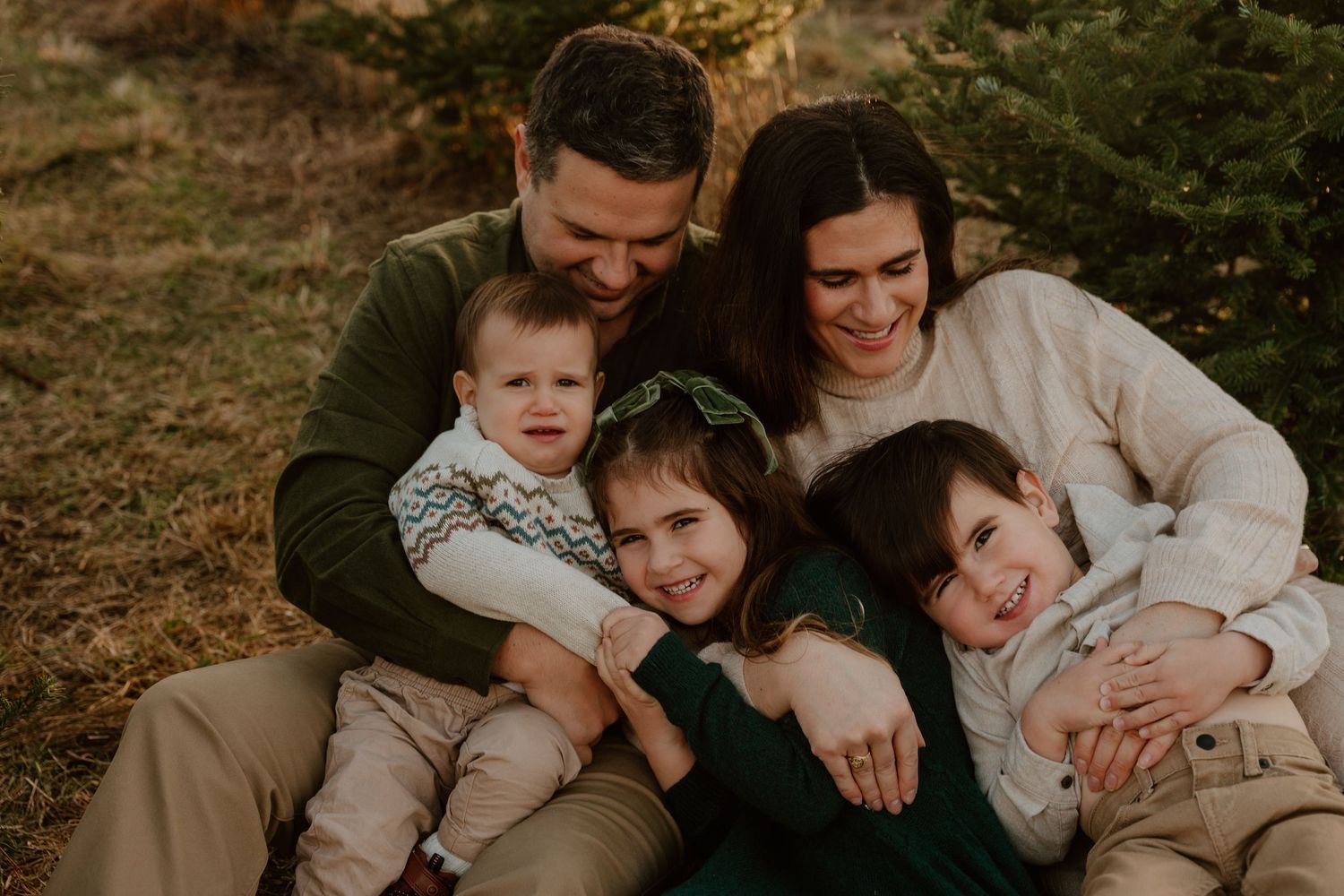 A collection of warm-toned family portrait photos showing candid moments and embraces outdoors at sunset.