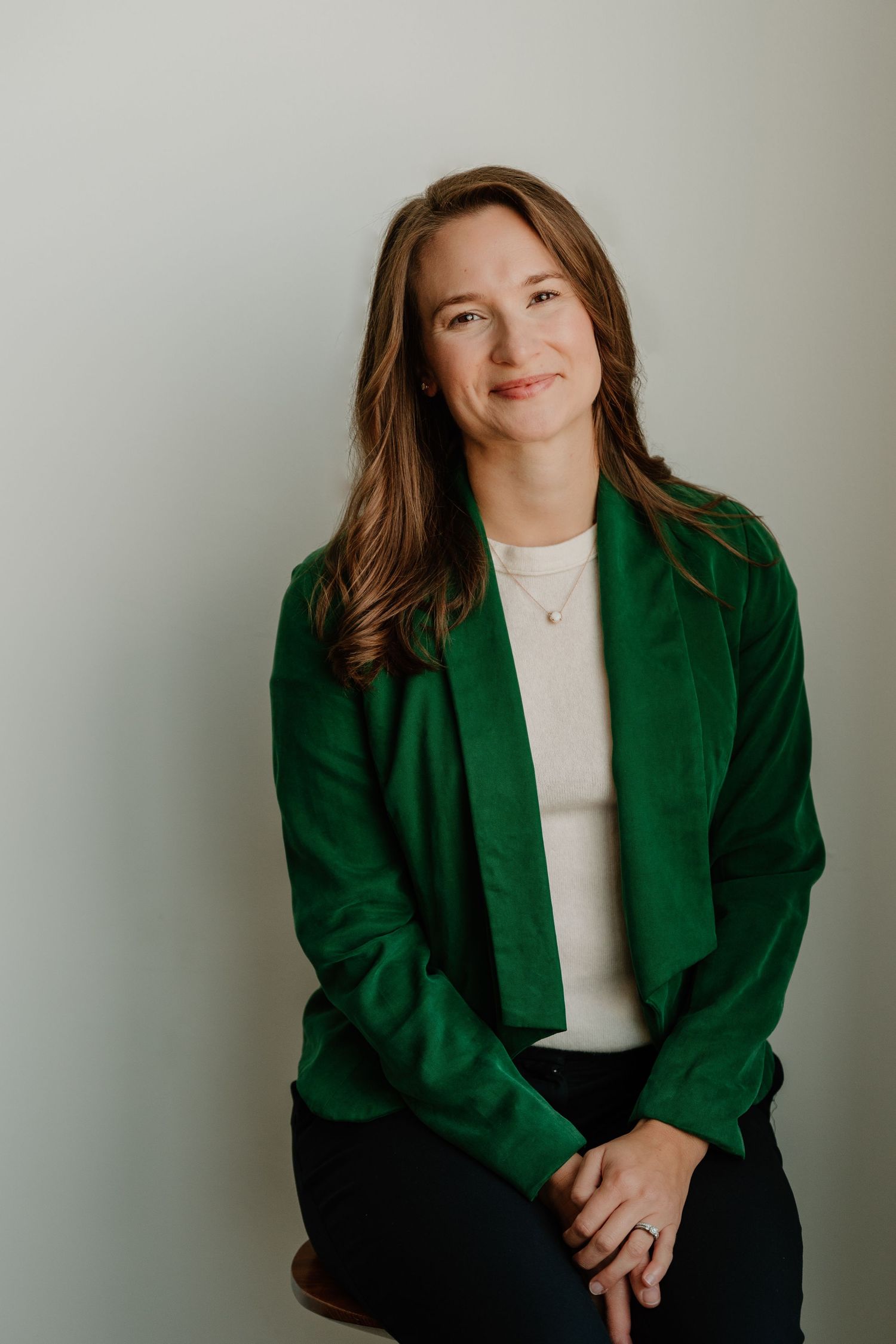 Professional portrait series showing a person in a green blazer and white top against a light background.