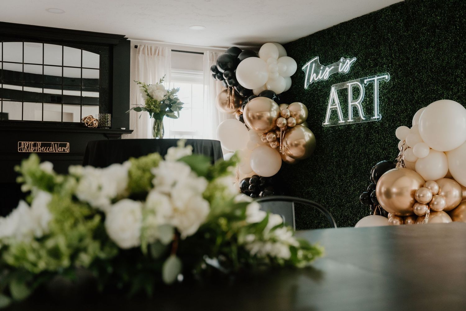 Modern wedding venue decorated with elegant white balloons and neon signage creates a contemporary romantic atmosphere.
