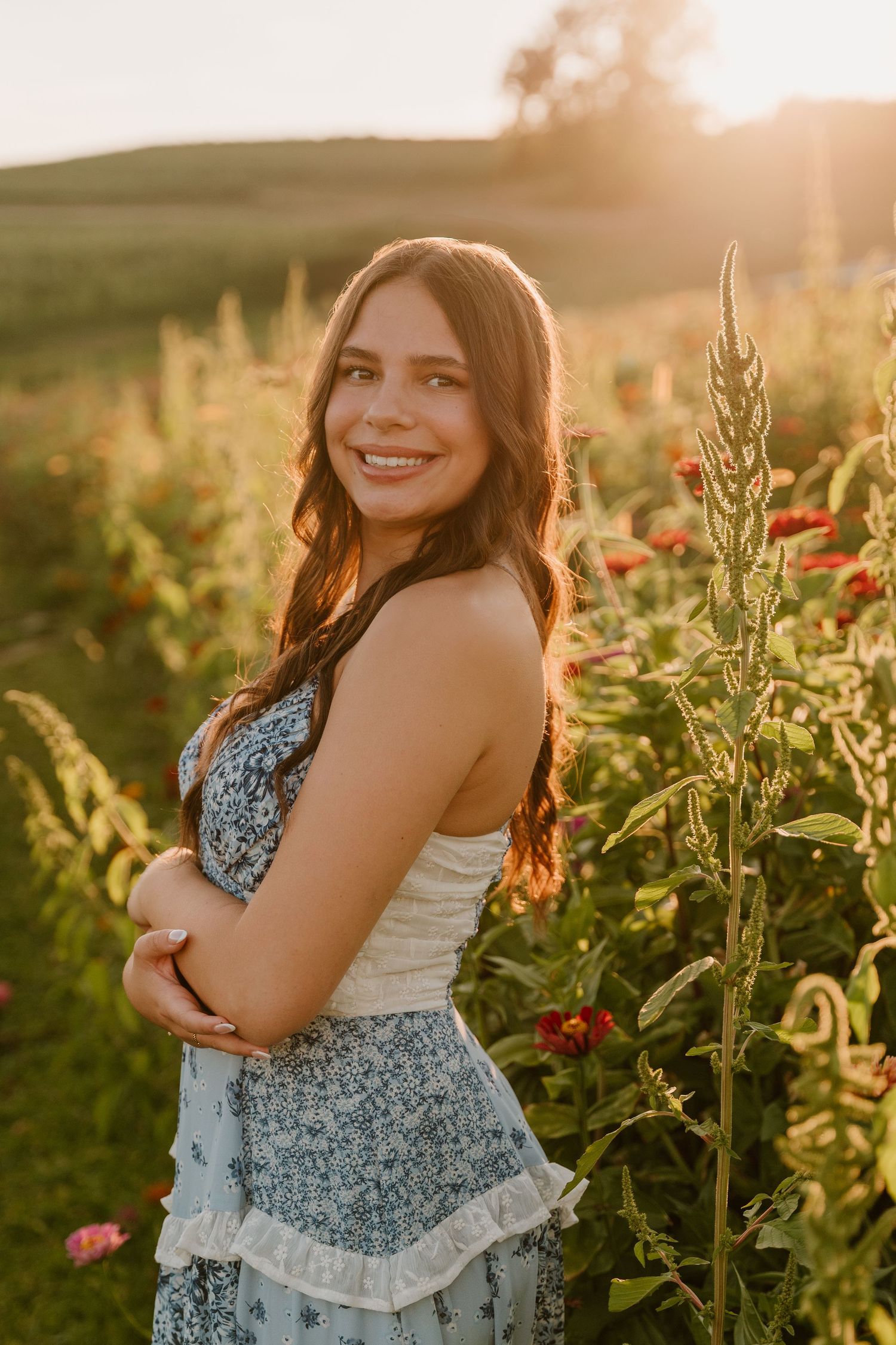 Sunlit portrait session in a wildflower field with poppies at golden hour showing joyful expressions and natural poses.
