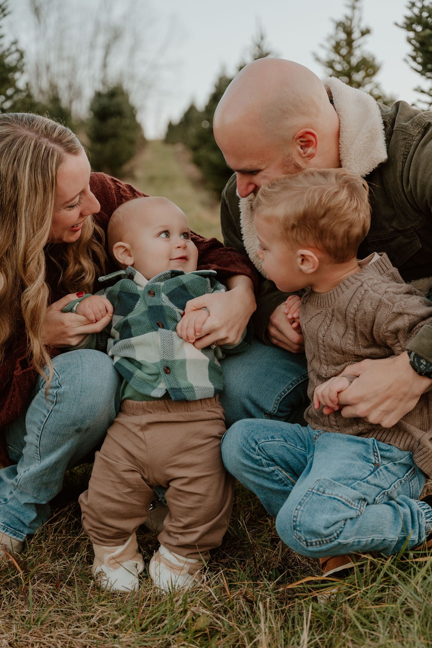 A series of candid family moments showing playful interactions while sitting together on grass outdoors.
