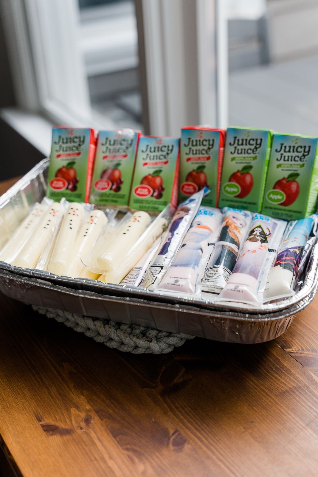 Party drinks display with Juicy Juice boxes and bottled beverages in an aluminum tray.