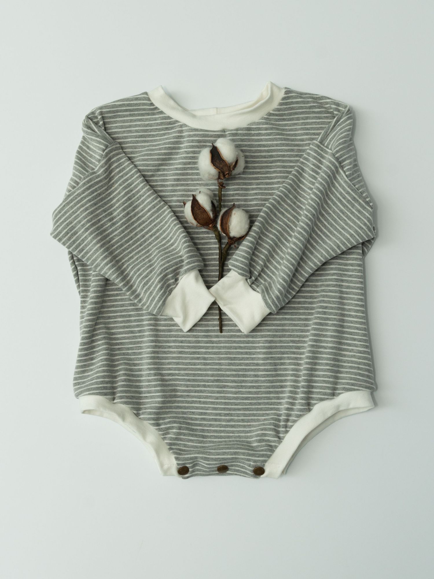 Four gray and white striped baby onesies with peter pan collars displayed in a row showing different angles.