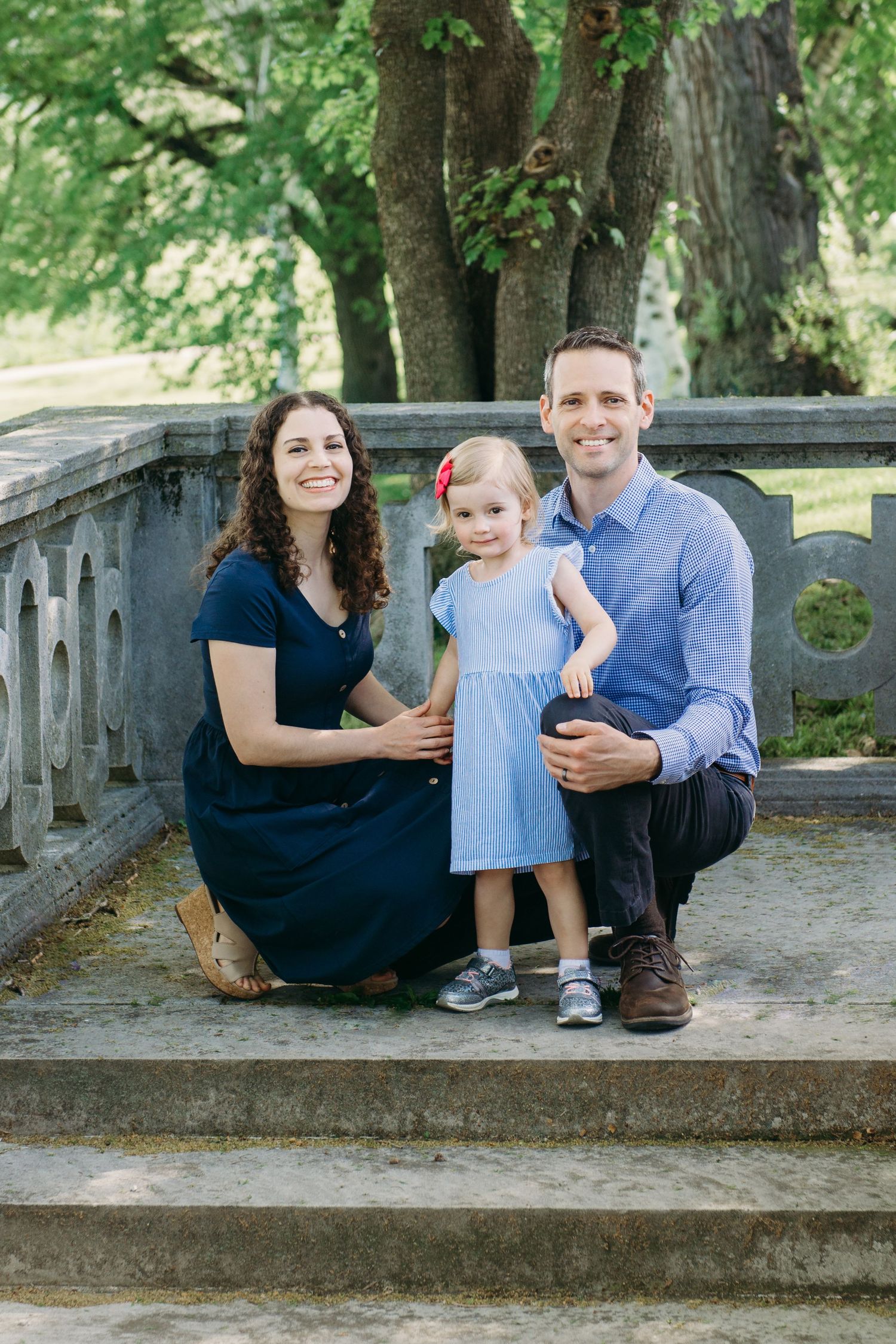 family of three on steps at Mellon Park for family portraits