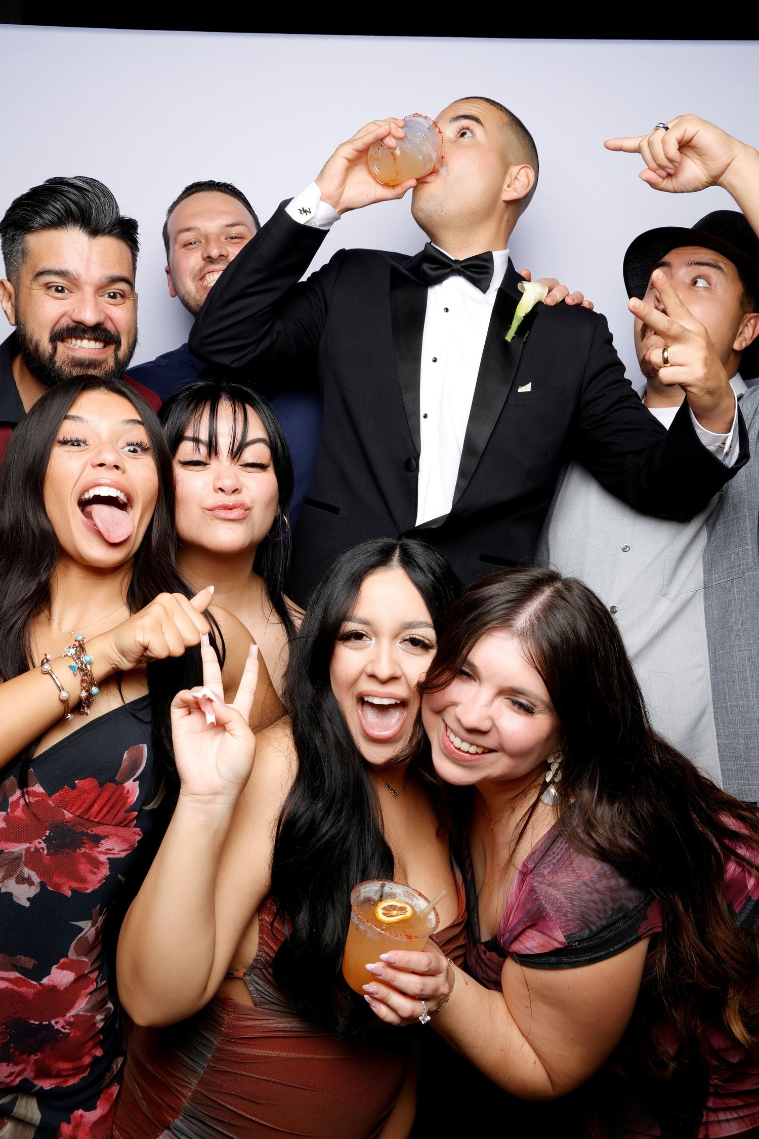 Lively photo booth shots showing a group making silly faces and poses together.