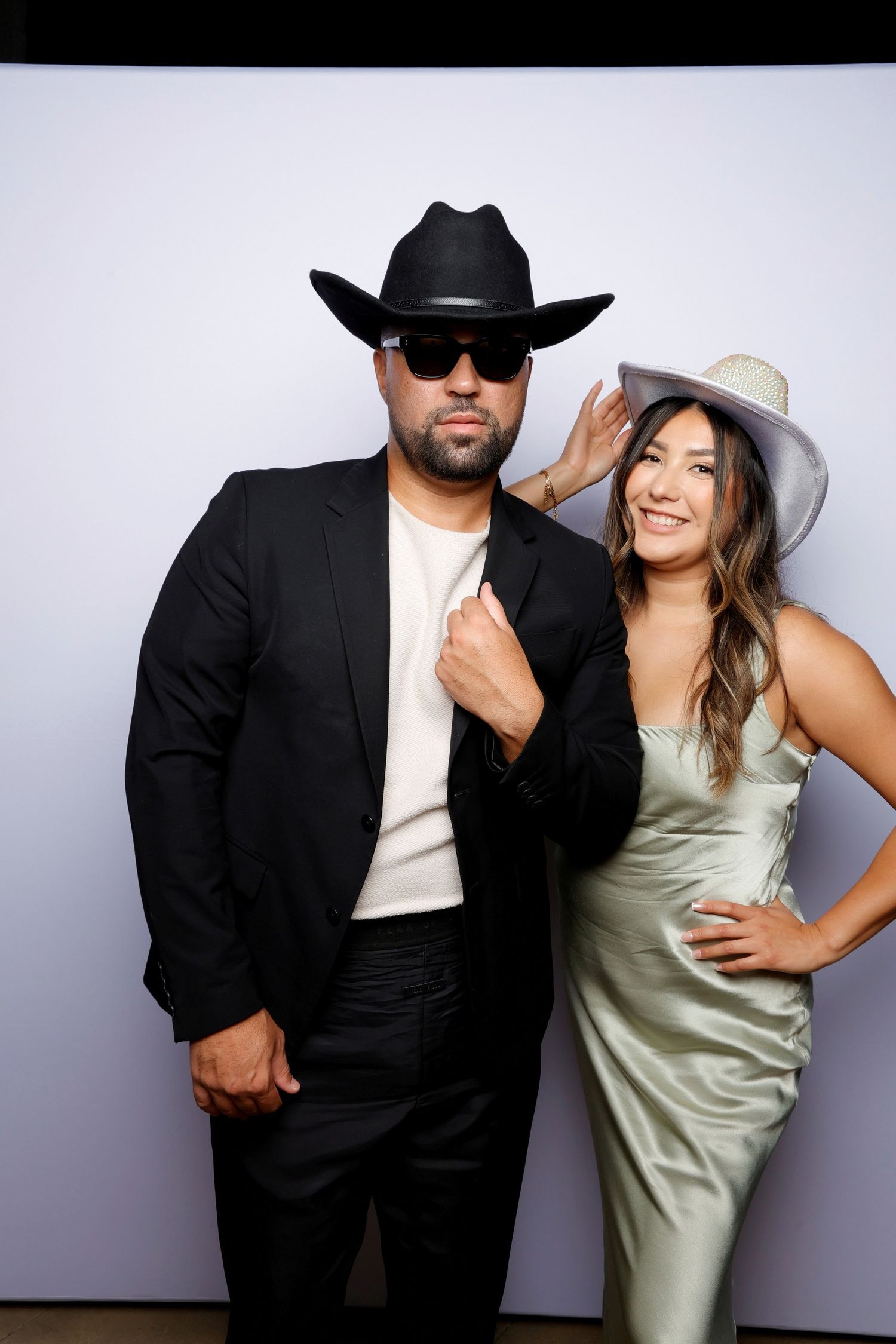 Photo booth sequence of couples in formal wear striking playful poses against white backdrop.