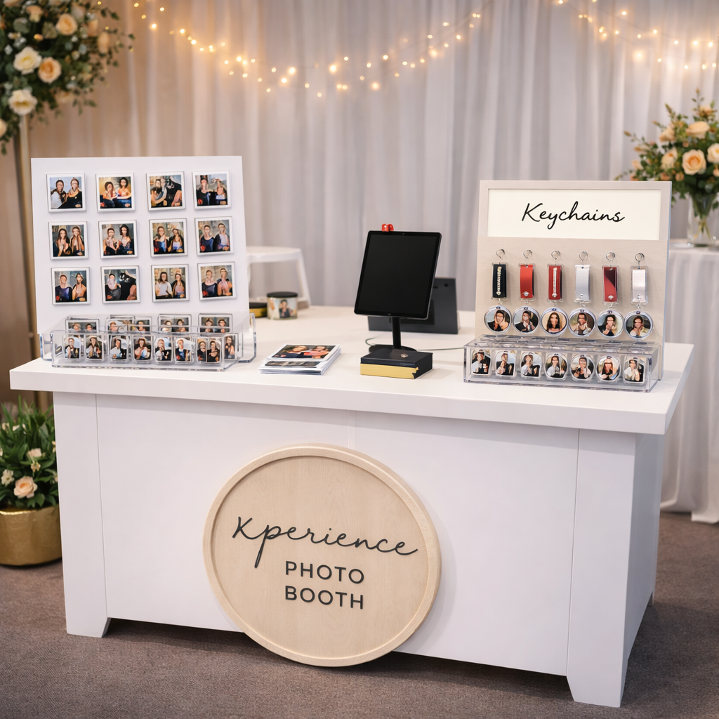 An elegant photo booth display setup with prints, props and lights at a wedding reception.