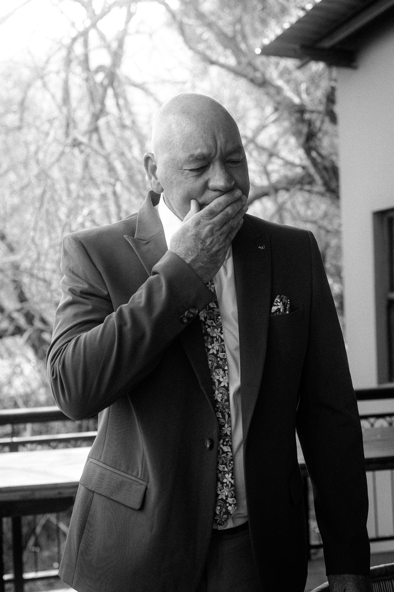 Man in suit emotional outdoors in Garden Route wedding photography