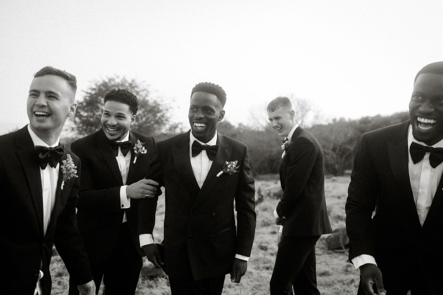 Groom and groomsmen in suits outdoors at a Garden Route wedding
