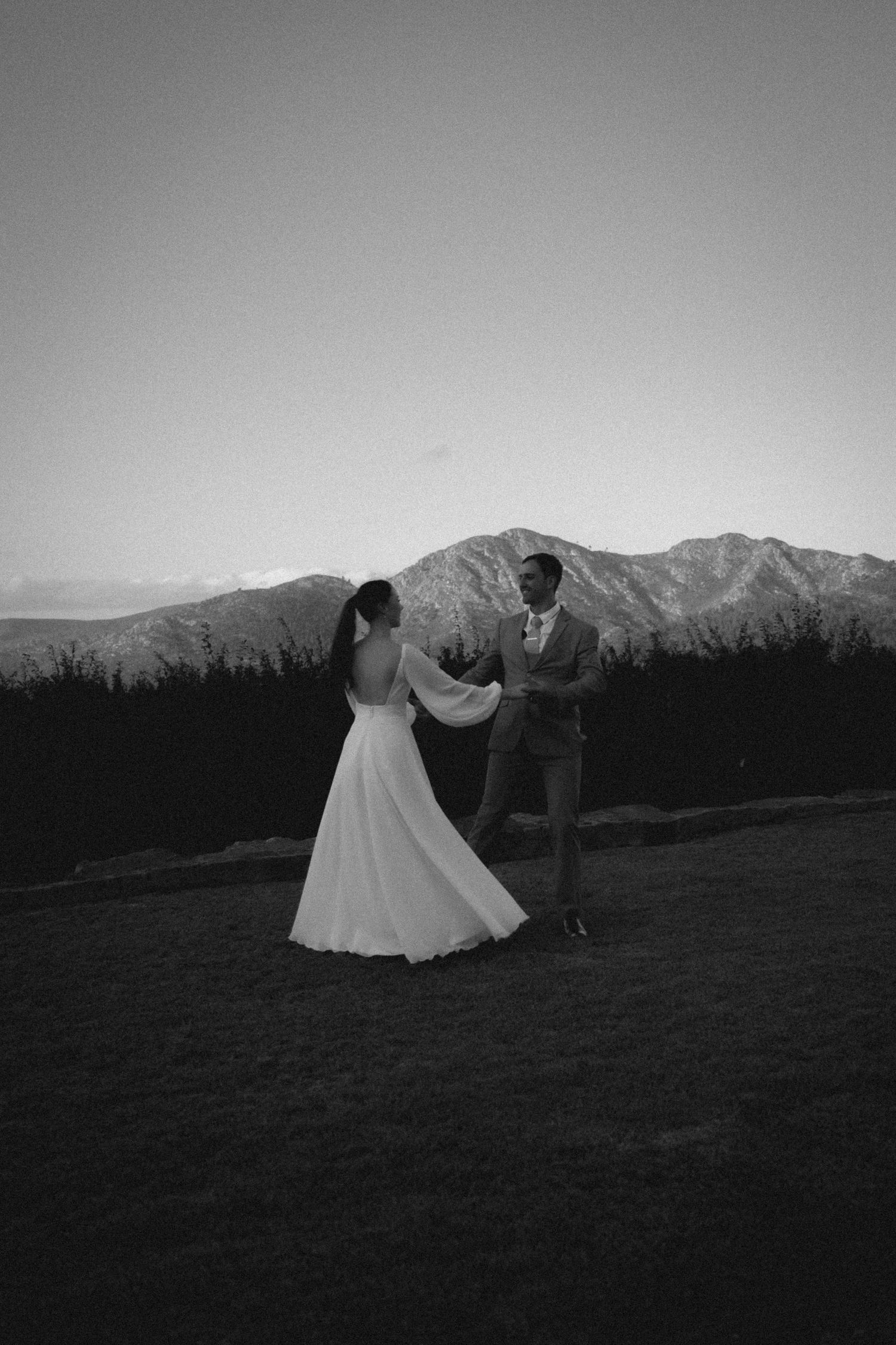 Bride and groom dancing outdoors with mountain backdrop in South Africa wedding film