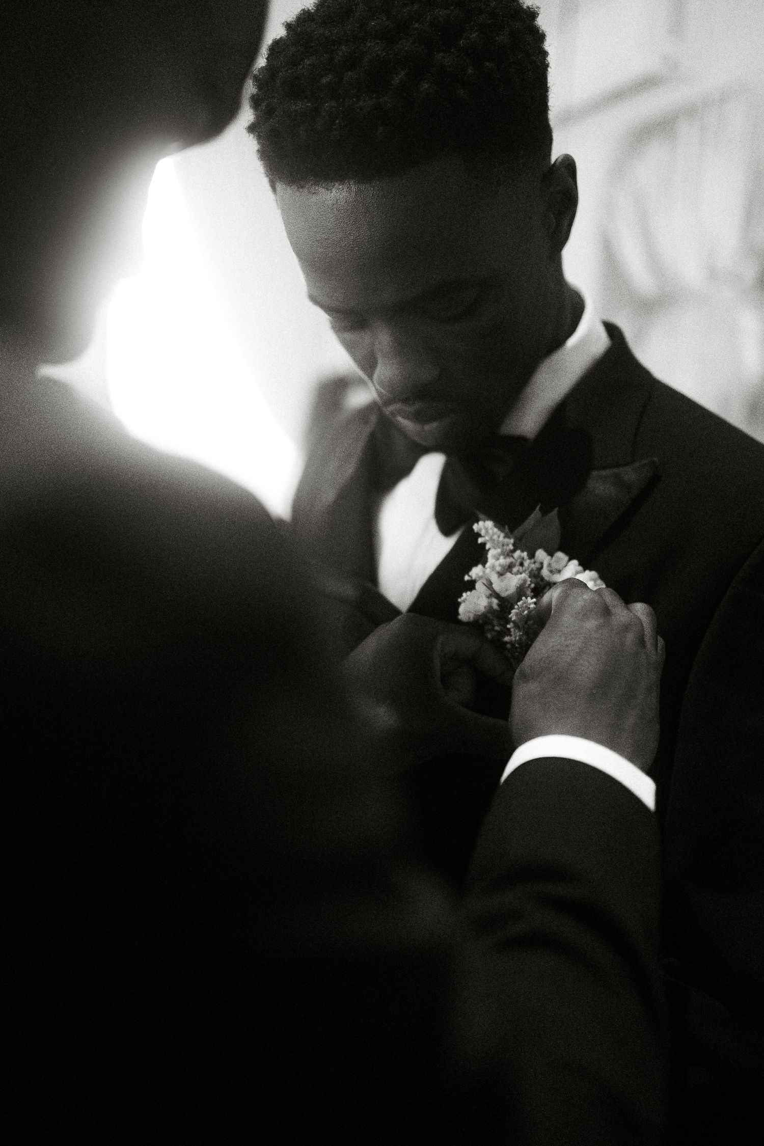 Groom having boutonniere pinned in intimate Garden Route wedding