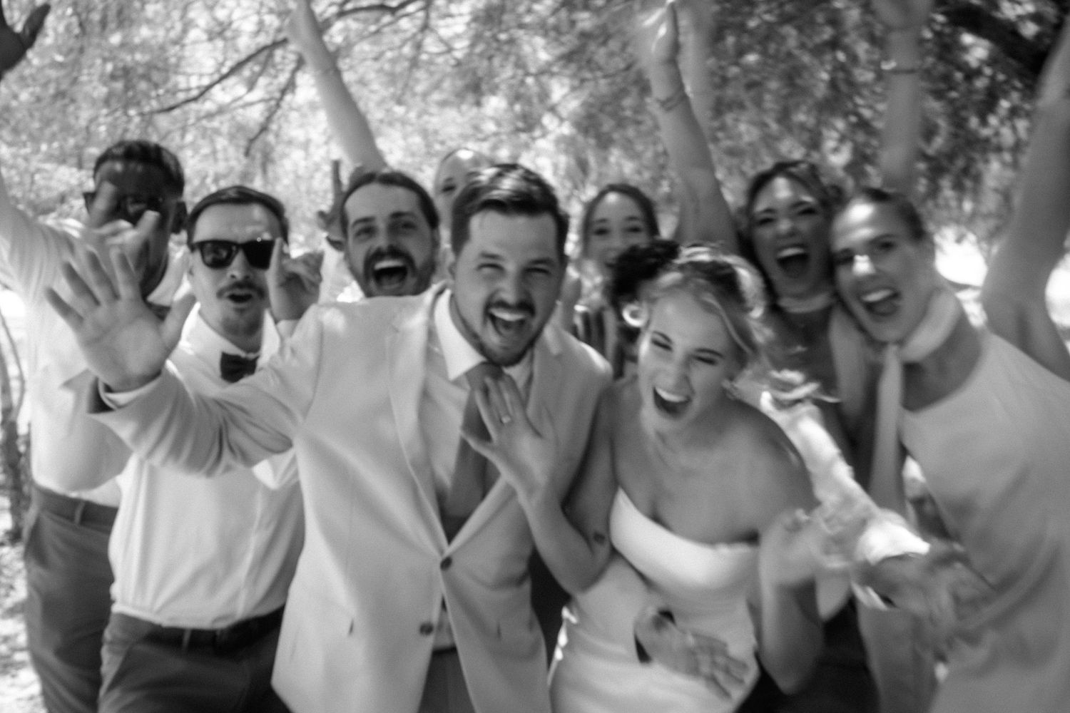 Joyful wedding party celebrating outdoors in the Garden Route, South Africa