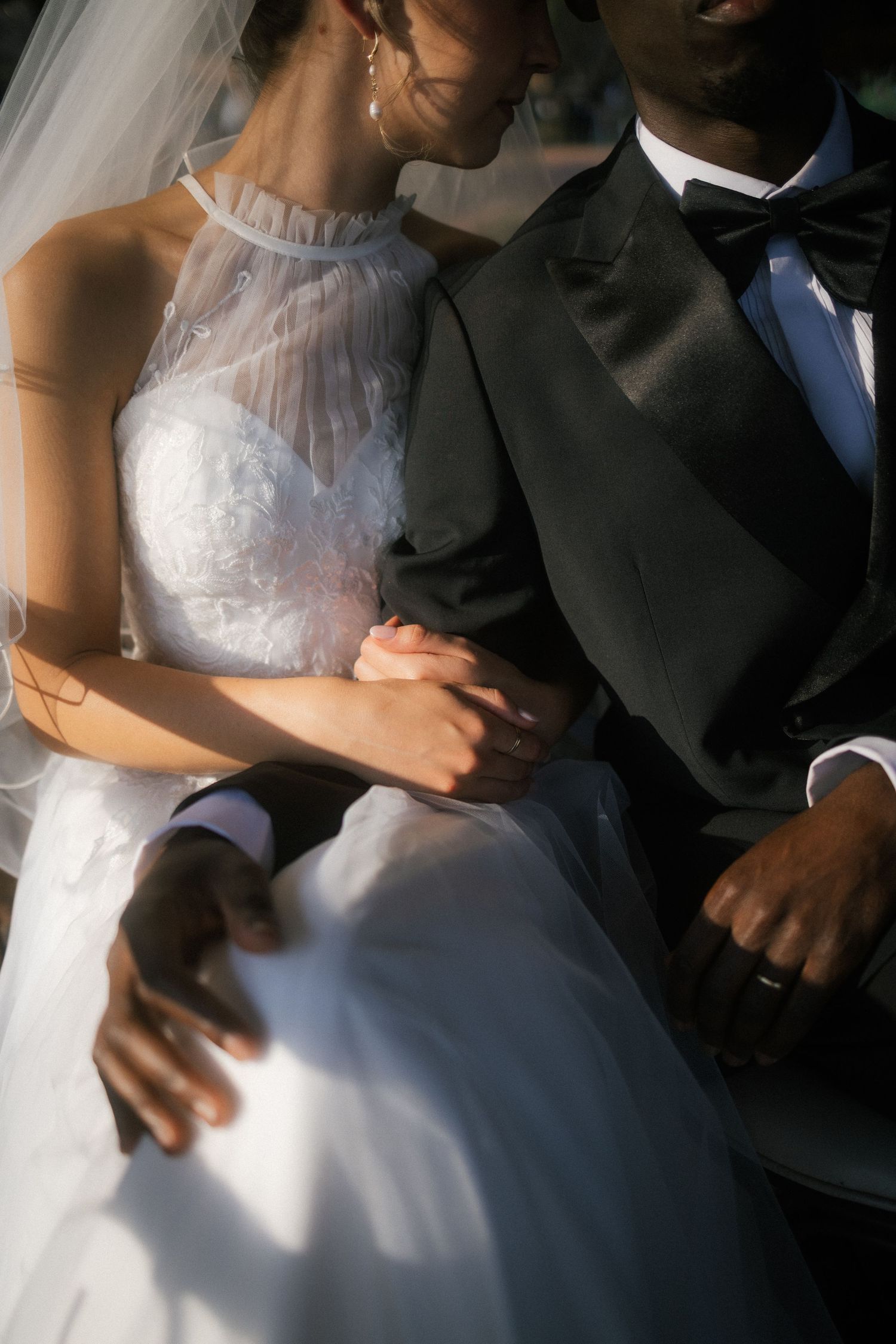 Bride and groom sitting closely in wedding attire, captured by Garden Route engagement photographer