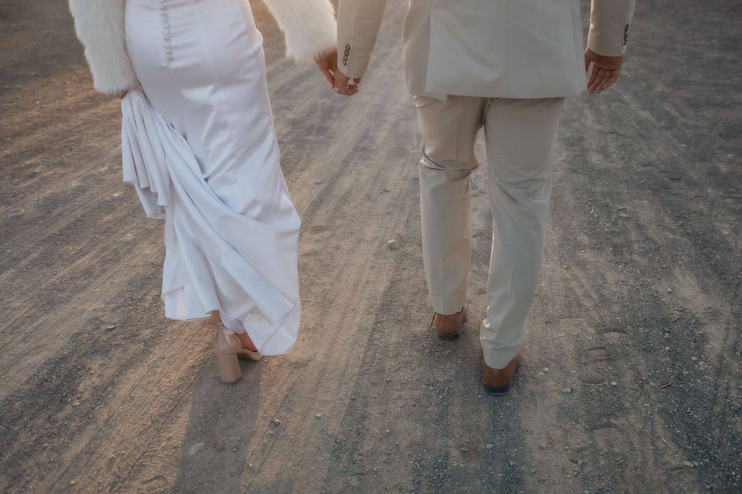 Bride and groom walking hand in hand on gravel road, Garden Route wedding photographer