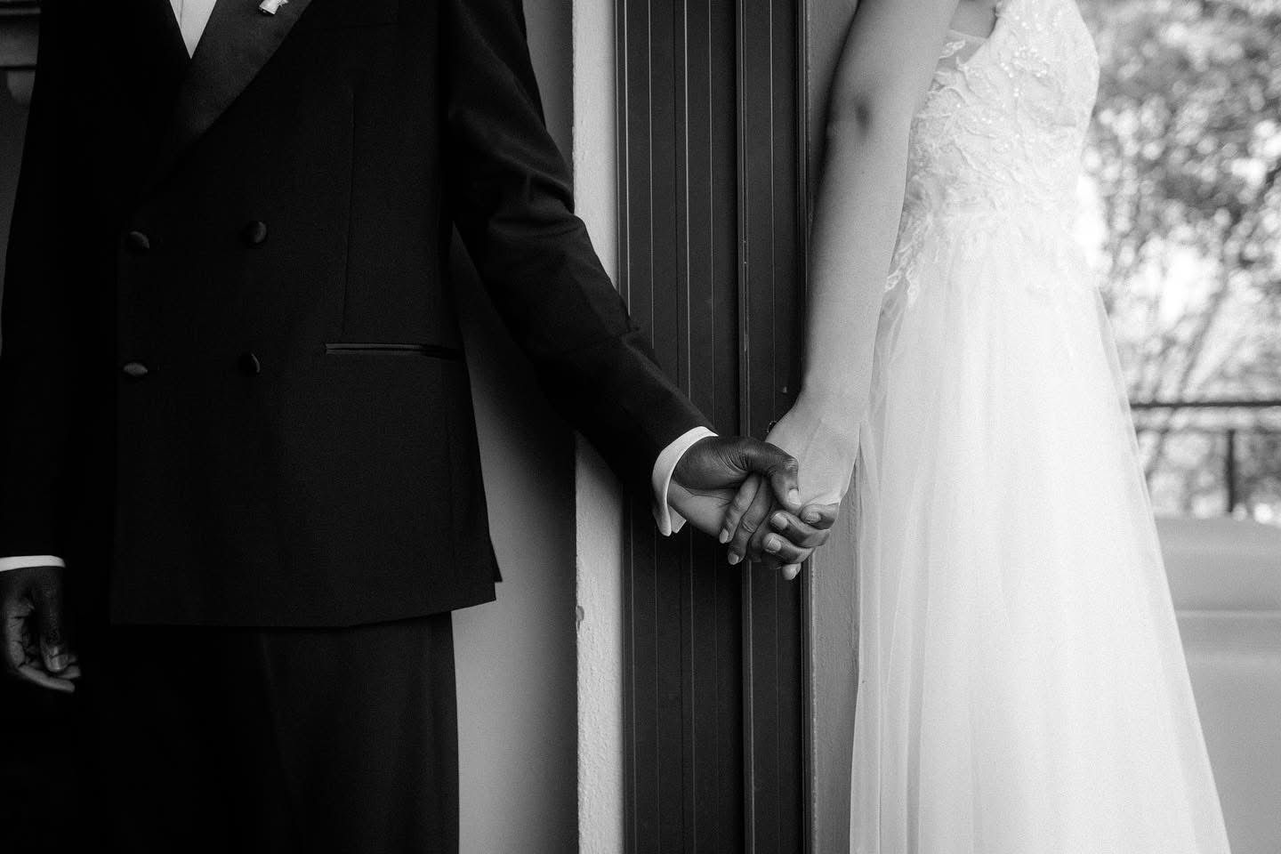 Bride and groom holding hands in black and white wedding photo Garden Route