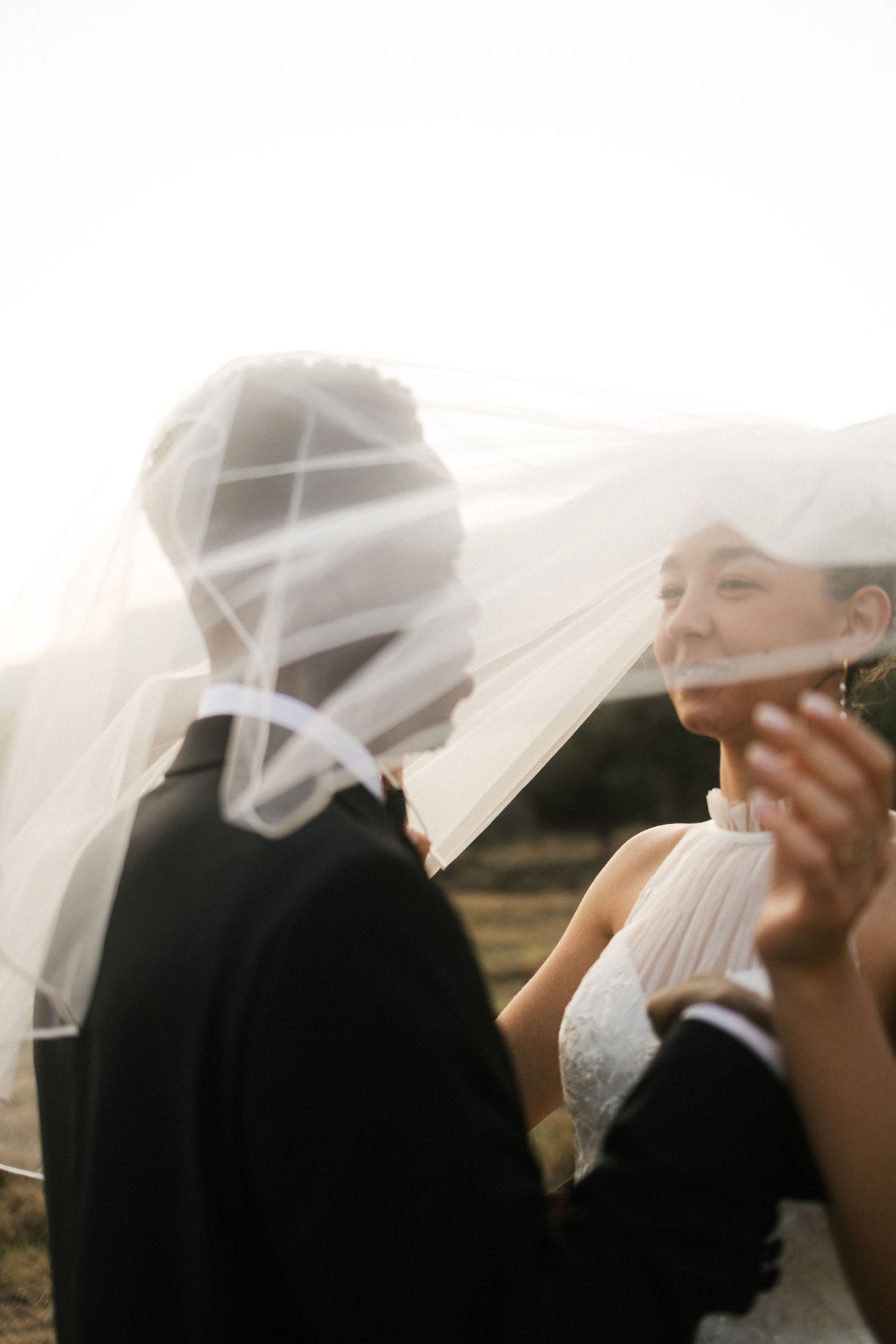Bride and groom sharing intimate moment with veil during Garden Route wedding