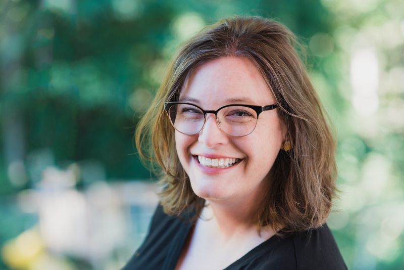 Professional headshot portrait series showing warm expressions and natural outdoor lighting with blurred green foliage background.