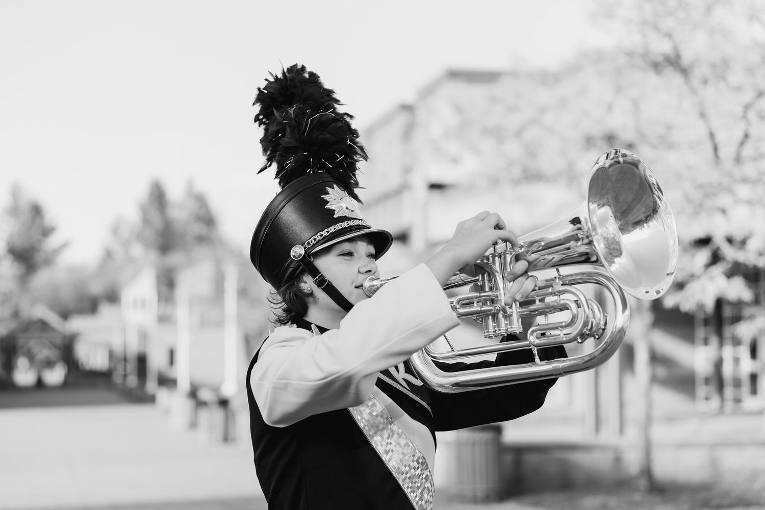 A black and white photo collage showing a musician playing trumpet in different outdoor settings and poses.