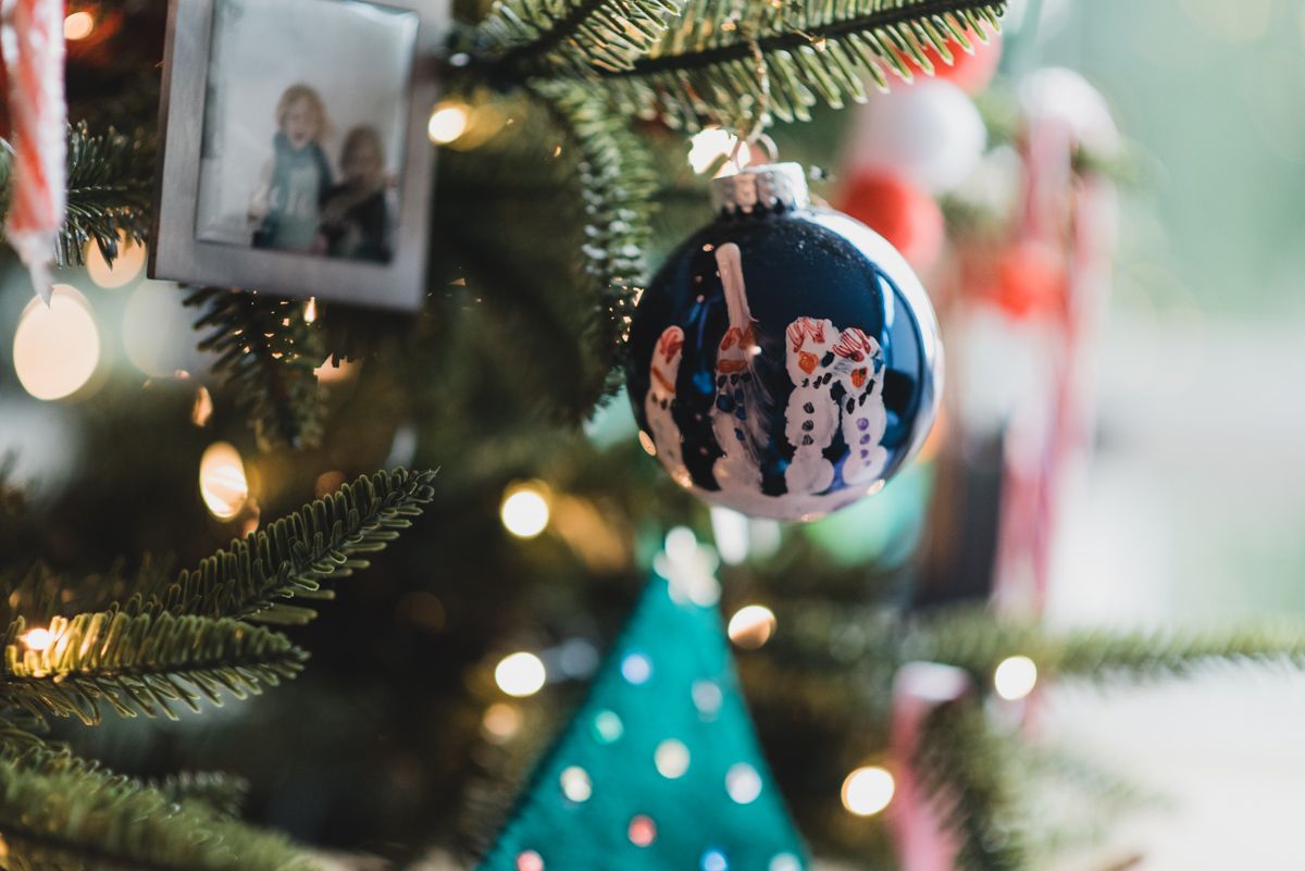 Close up of Christmas tree branches with twinkling lights and decorations.