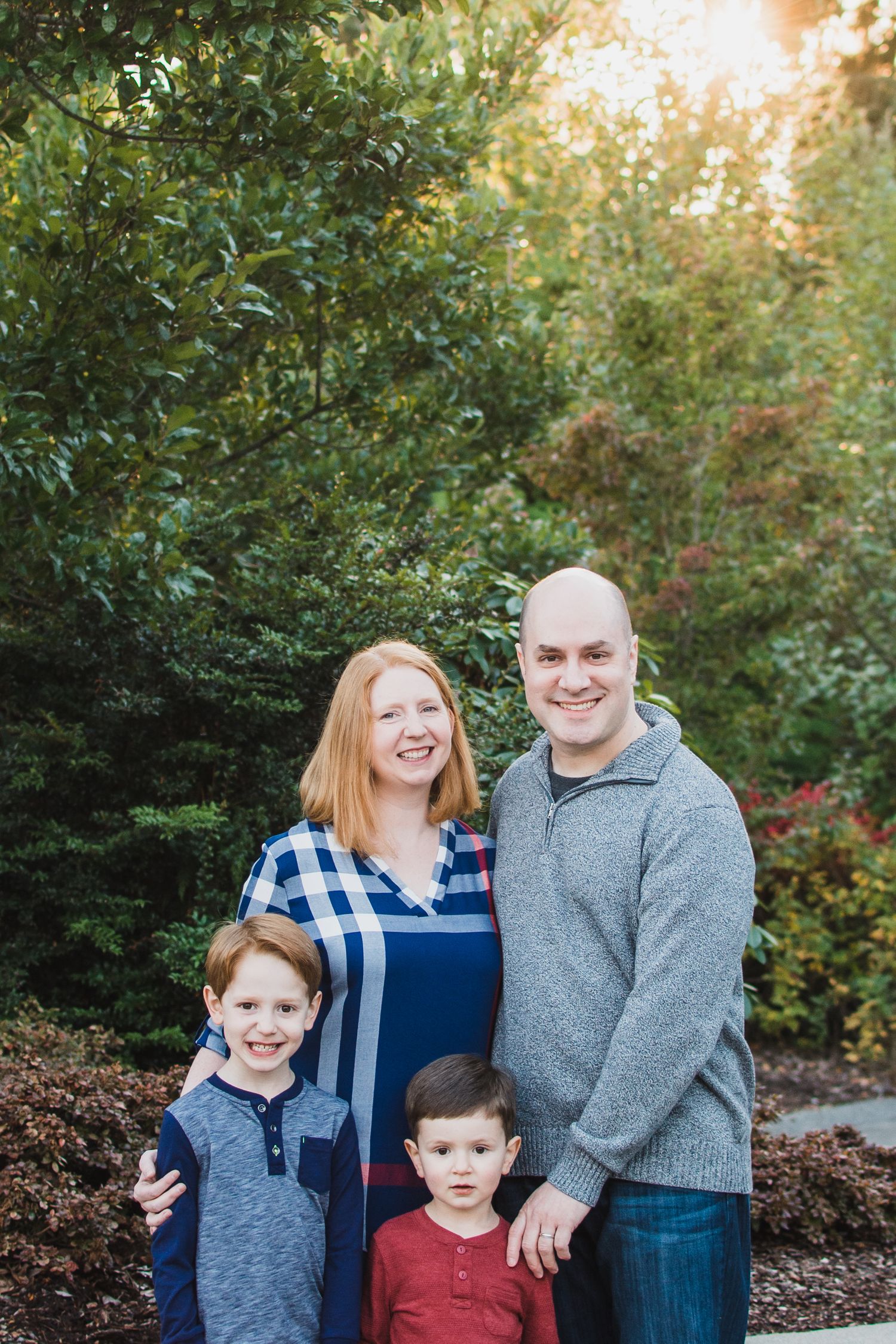 posed family of 4 looking straight at the camera