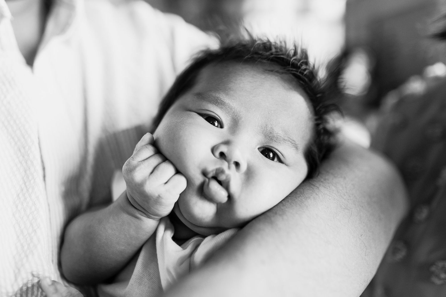 Black and white photo series showing a baby's different facial expressions and moods.