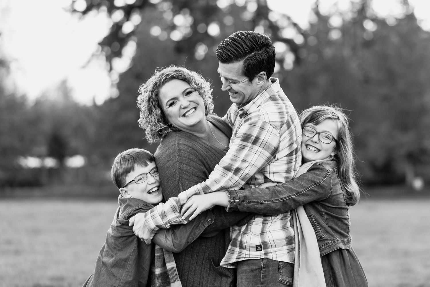 family of four in a big hug
