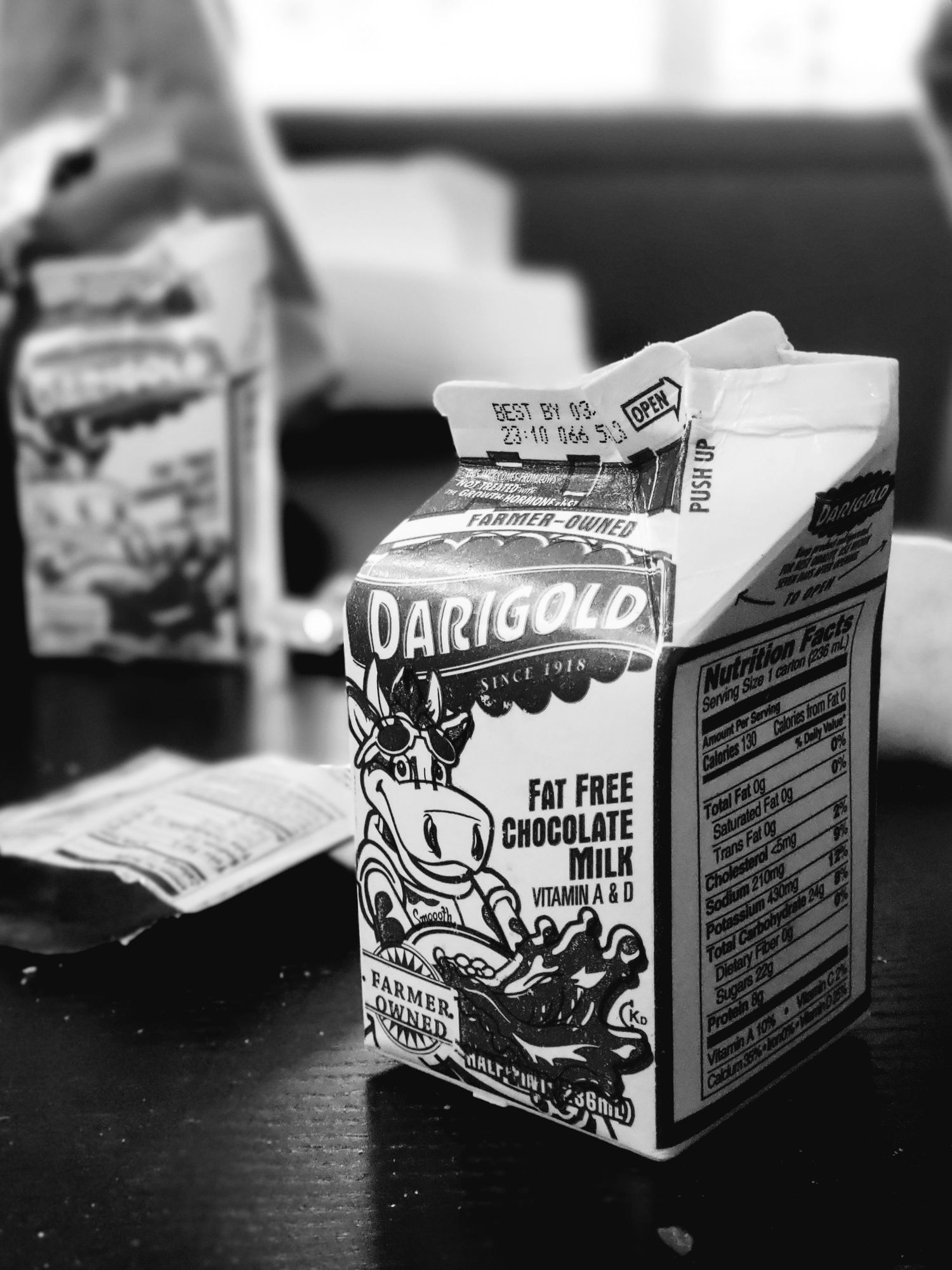 black and white photo of a school lunch Darigold milk box
