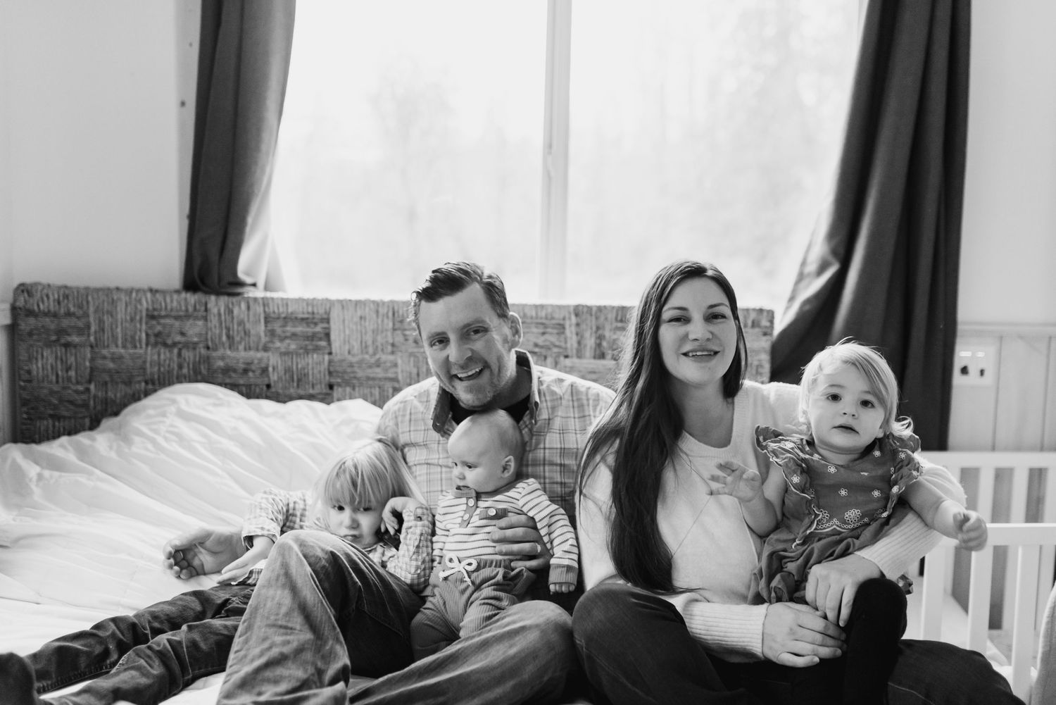 A collage of black and white photos showing a family relaxing and spending time together at home.