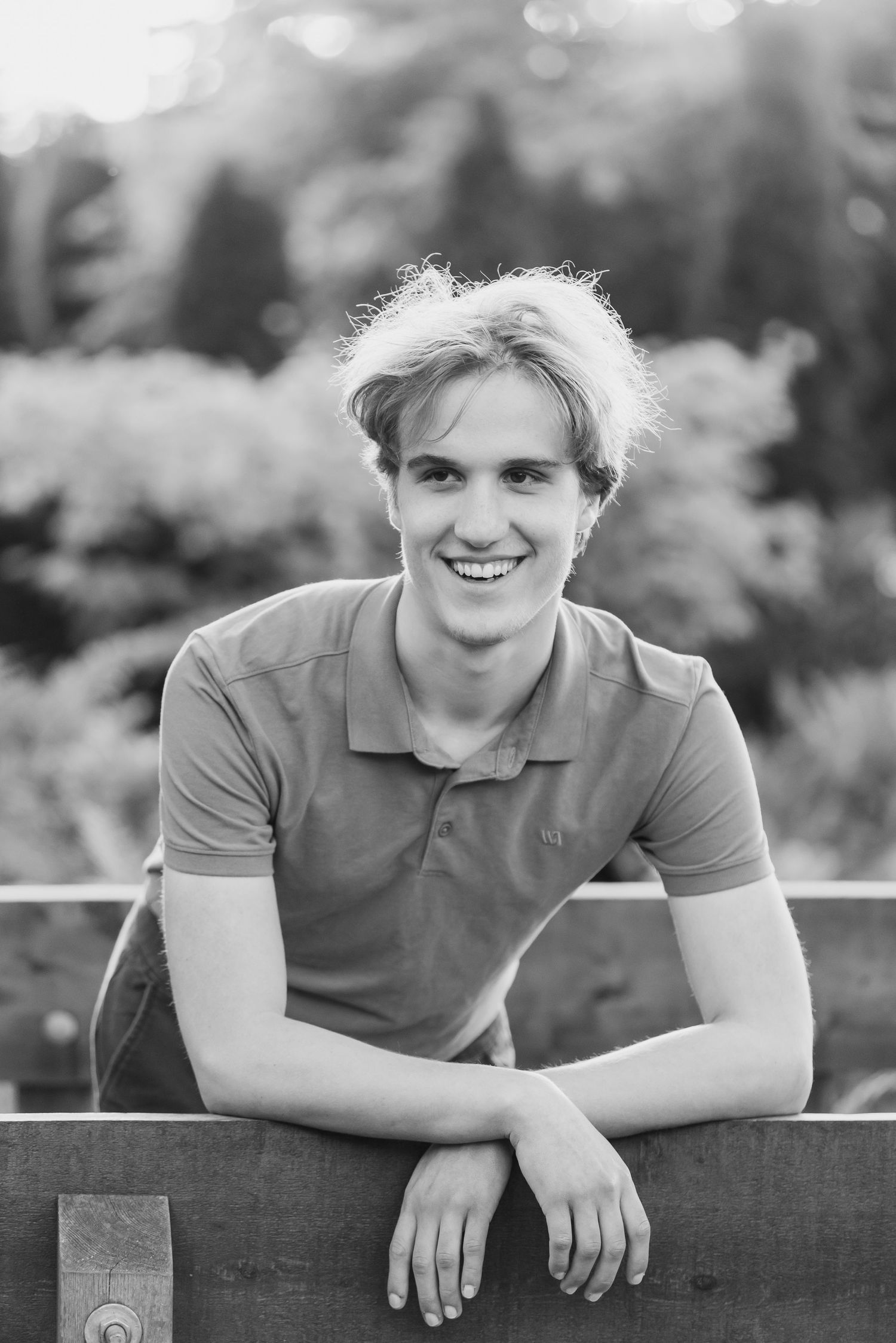 Black and white portrait series showing someone leaning on a railing with casual expressions in an outdoor setting.