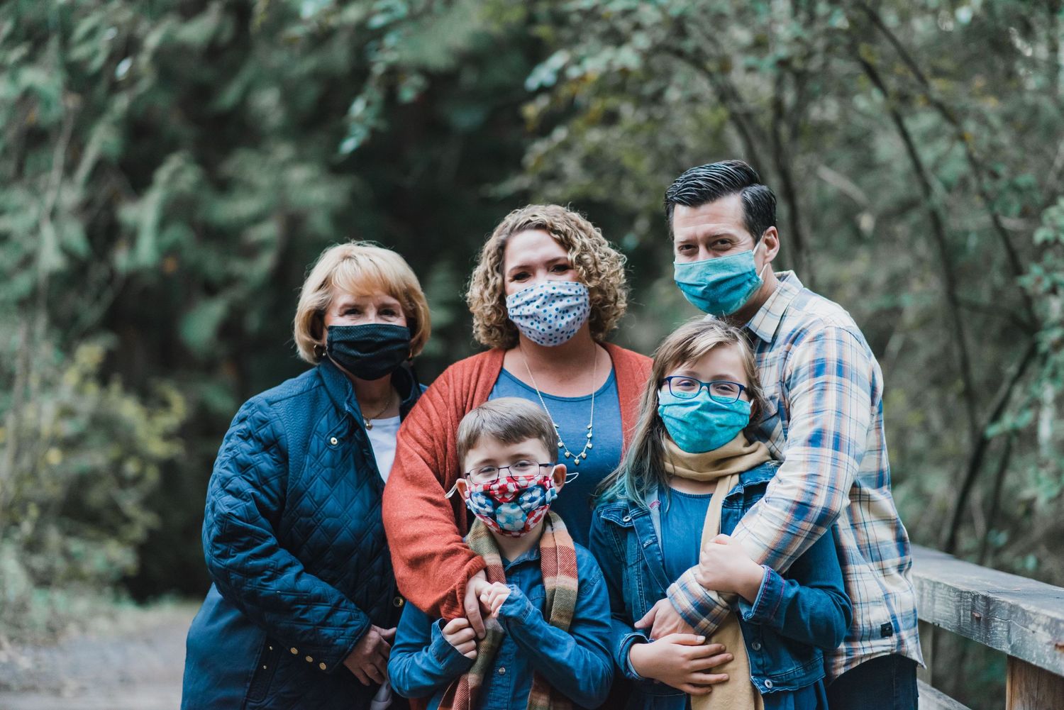 Family photo with everyone wearing masks