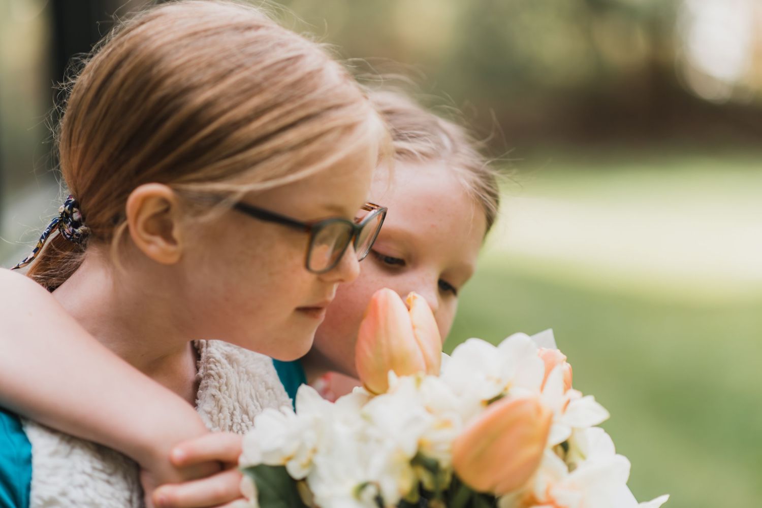 Sweet moment shared between two people with a beautiful floral bouquet against a blurred natural background.