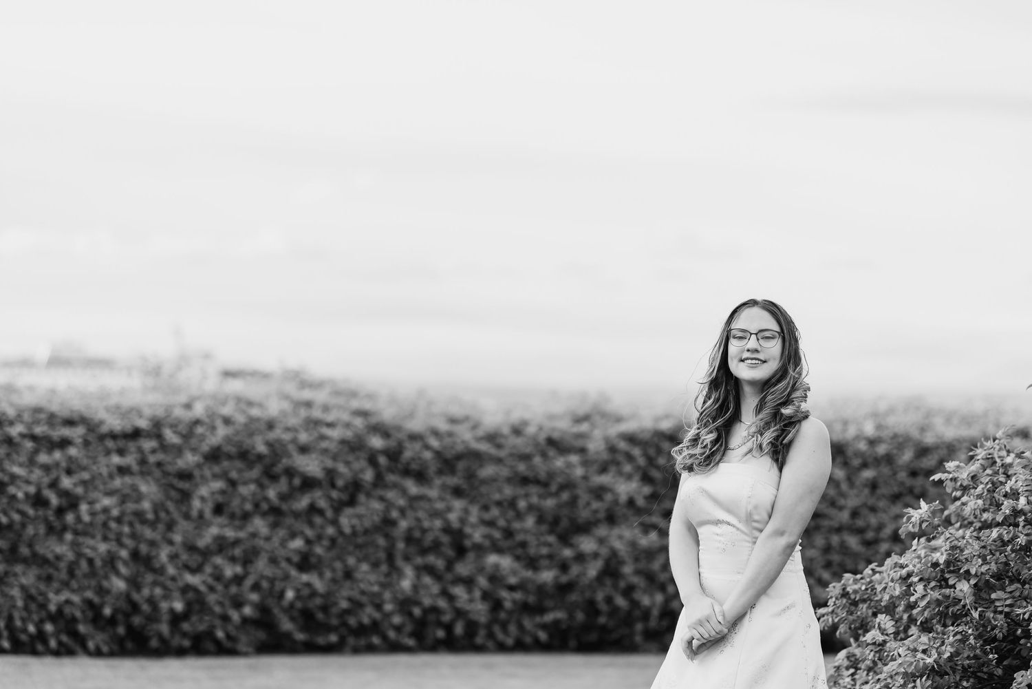 A black and white photo collage shows joyful moments captured in an outdoor field setting.