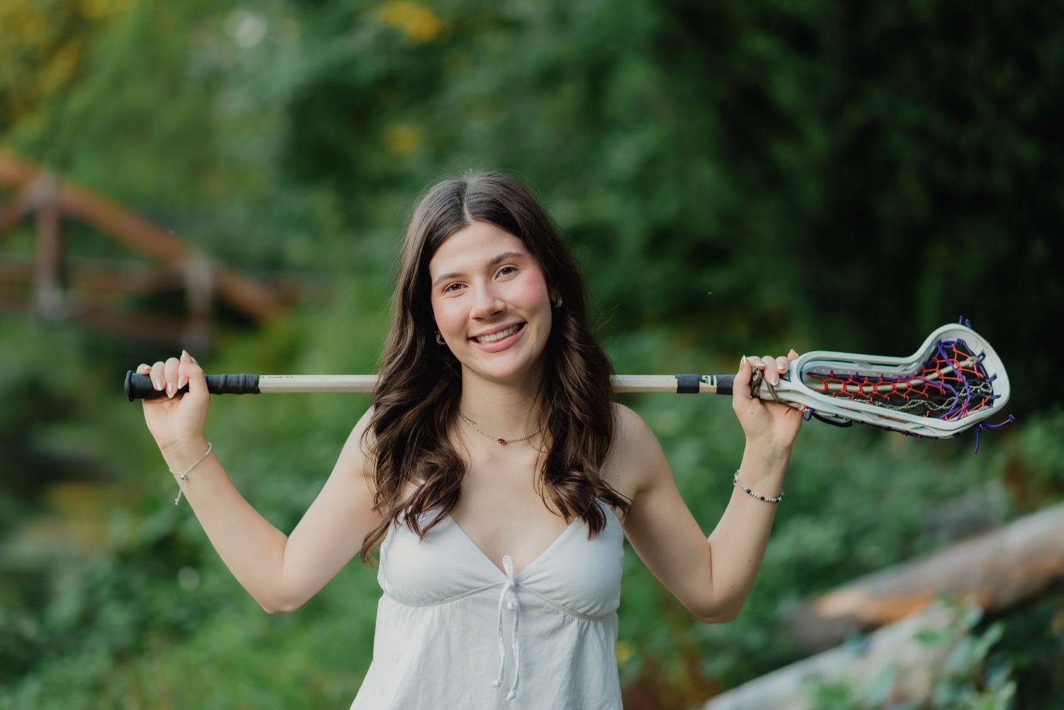 A series of outdoor portrait photos showing someone holding a snake against a green natural background.