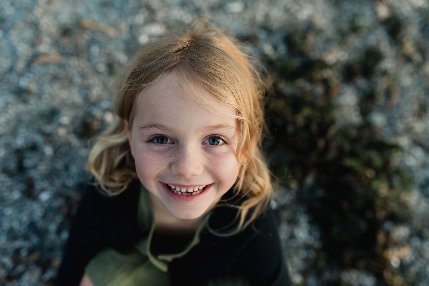 A series of five close-up photos showing a joyful expression against a blurred natural background.
