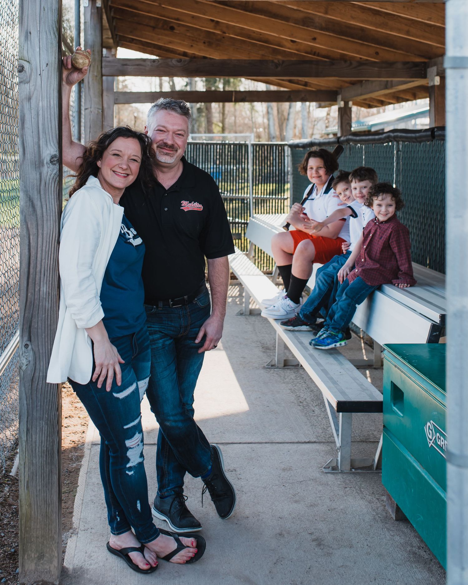 Parents and their 4 boys in dugout at Mukilteo Little League fields