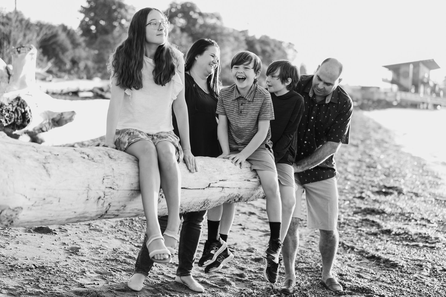 A sequence of black and white photos showing people playing and interacting on a beach.