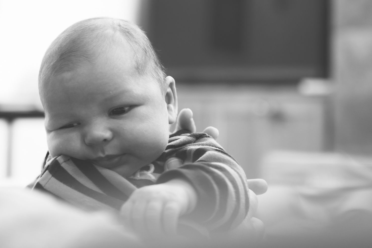 A collection of four black and white photos showing someone eating spaghetti noodles with enthusiasm.