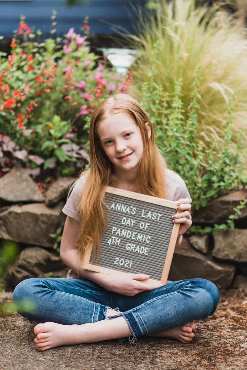 girl holding sign for the last day of 4th grade