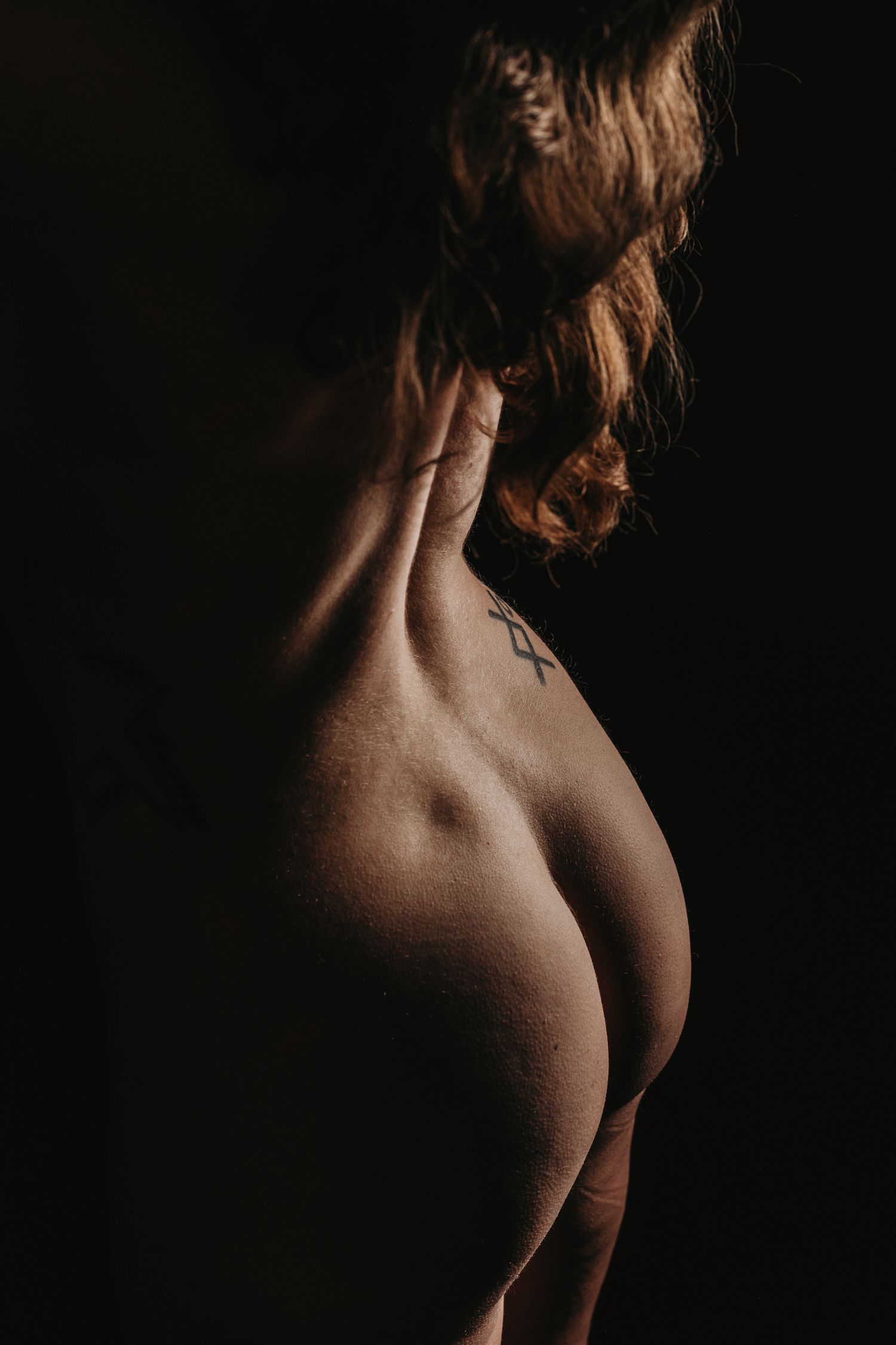 Artistic boudoir photo series in dark red and black tones. Nude Silhouette dramatic boudoir photography. Boudoir Photographer Grand Rapids