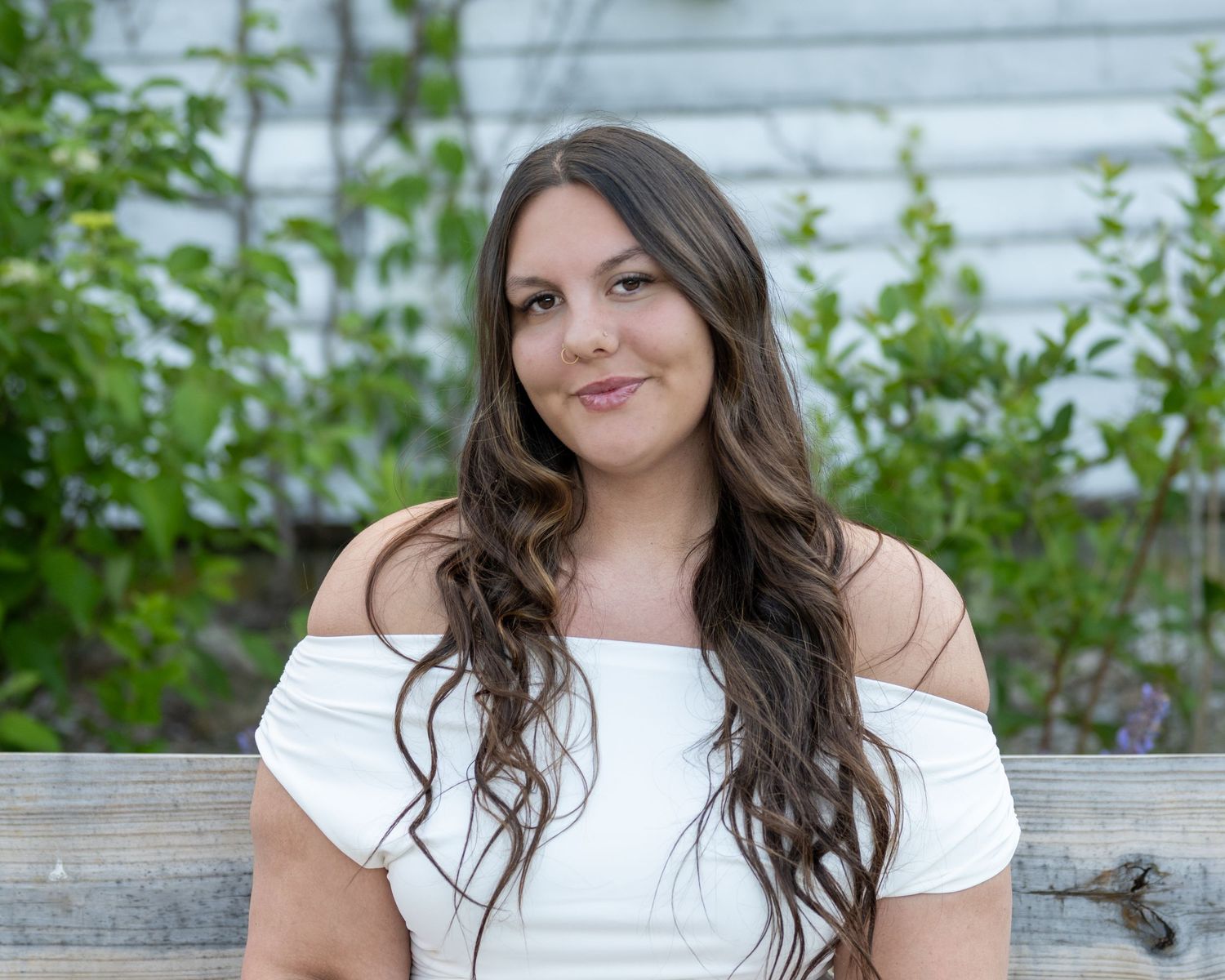 Graduating college senior looks confidently into the camera. She looks empowered