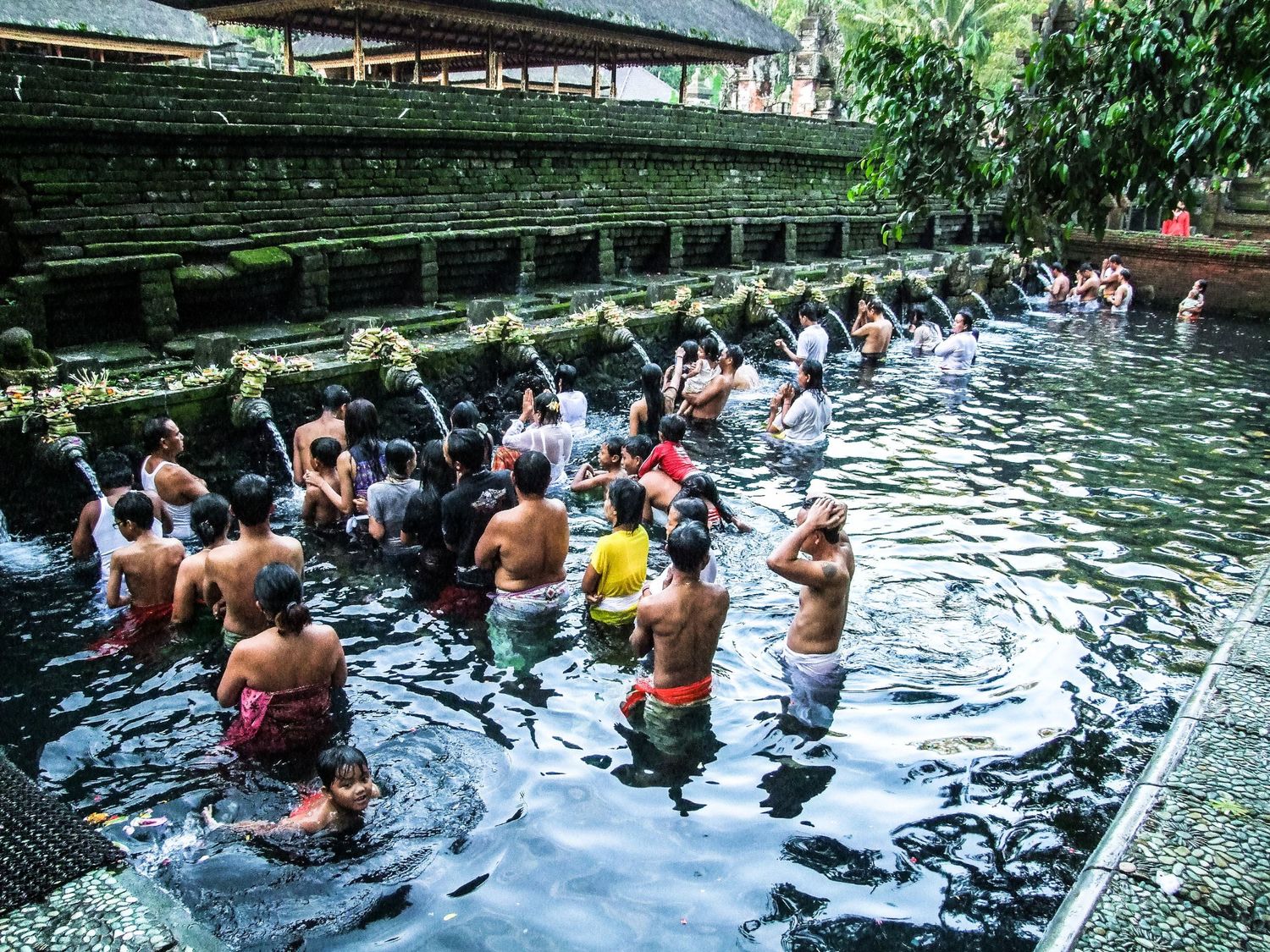 Des fidèles se purifiant dans les bassins sacrés du temple de Tirta Empul à Bali, par Jérémie Botte.
